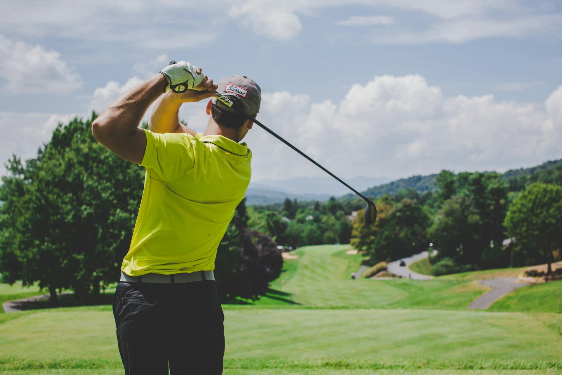 Golfer completing a swing on the fairway